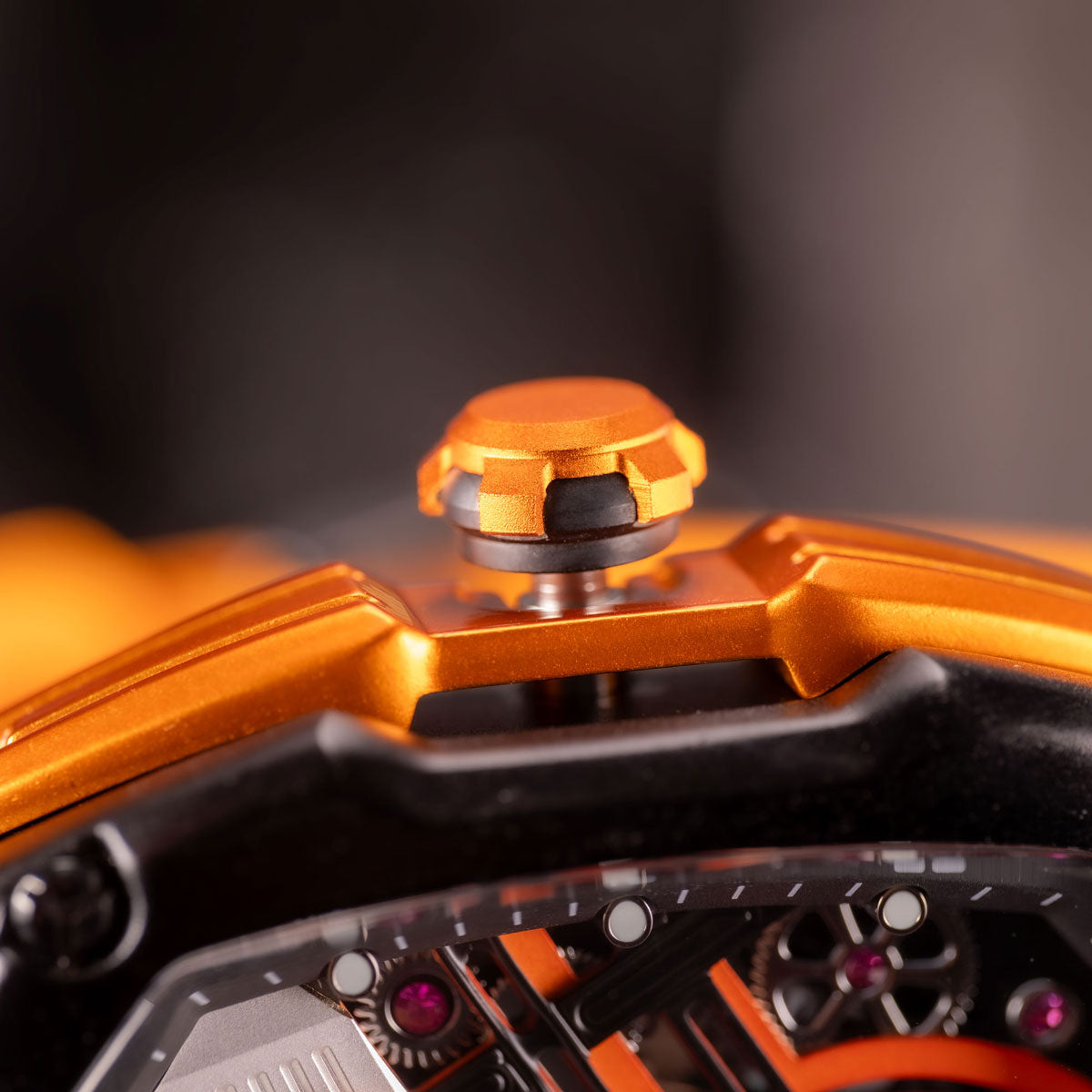 Close-up of an orange and black mechanical object with intricate details.