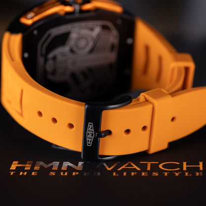 Orange watch with black face on a dark background, featuring the brand 'HMN WATCH'.